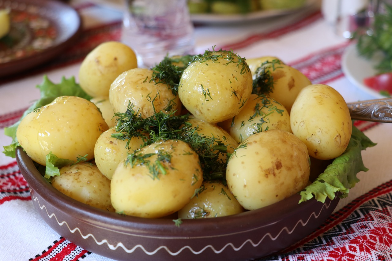 dish of boiled potatoes sprinkled with herbs