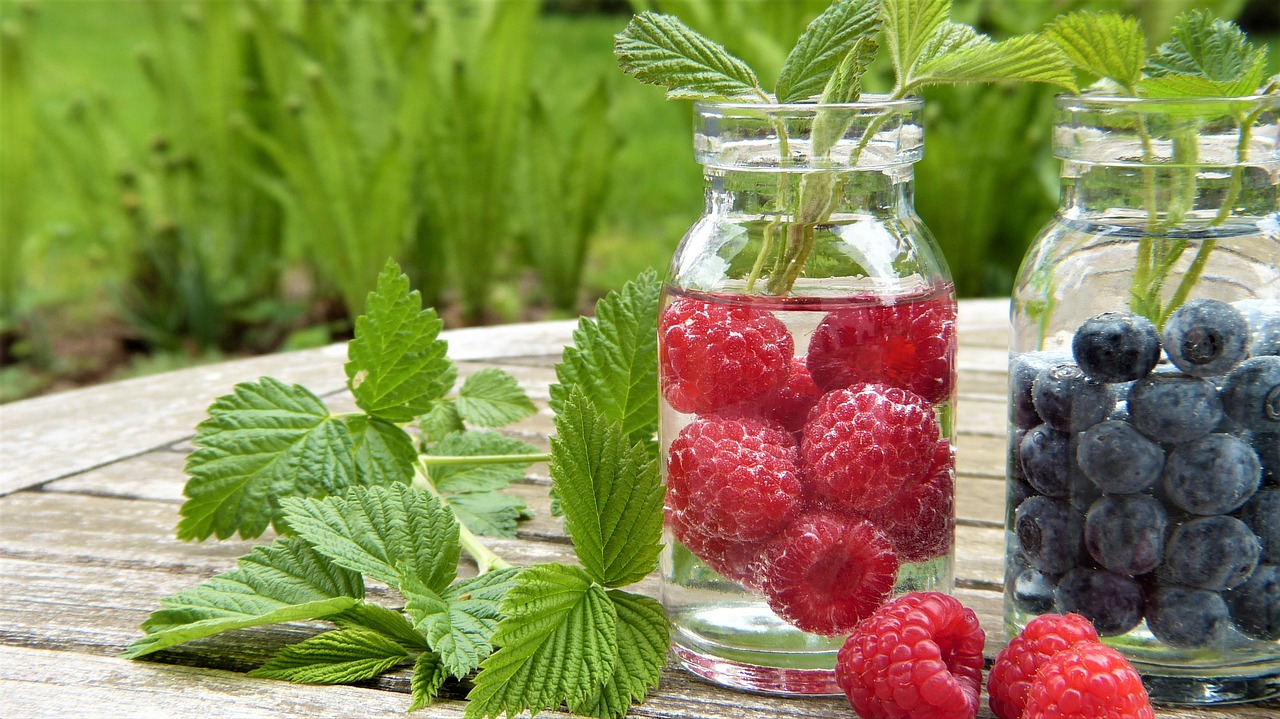 jars filled with raspberries and blueberries
