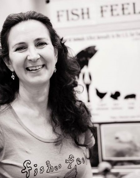 Mary Finelli smiling wearing a t-shirt that says Fishes Feel