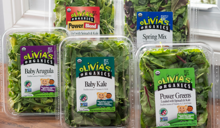 packages of Olivia's greens, including spinach, kale, arugula, and spring mix