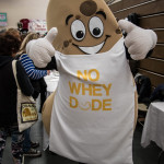 person dressed in a cashew costume gives two thumbs up