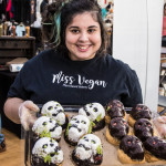 Miss Vegan vendor holding tray of Halloween-themed cookies