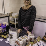 exhibitor poses at table