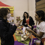 exhibitor talks with attendees about products