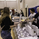 exhibitor talks with attendees about products