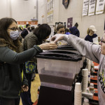 exhibitor talks with attendees about products
