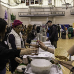 exhibitor talks with attendees about products