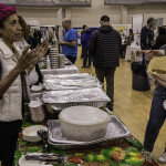 exhibitor talks with attendees about products