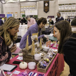 exhibitor talks with attendees about products