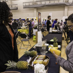 exhibitor talks with attendees about products