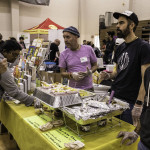 exhibitor talks with attendees about products