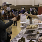 exhibitor talks with attendees about products