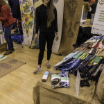 exhibitor talks with attendees about products