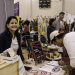 exhibitor talks with attendees about products