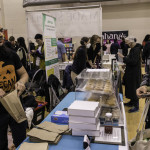 exhibitor talks with attendees about products