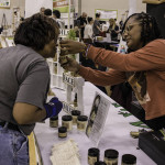 exhibitor talks with attendees about products