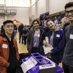 exhibitor talks with attendees about products