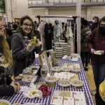 exhibitor talks with attendees about products