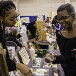 exhibitor talks with attendees about products