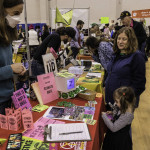 exhibitor talks with attendees about climate change