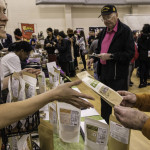 exhibitor talks with attendees about products