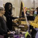 exhibitor talks with attendees about products