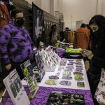 exhibitor talks with attendees about products