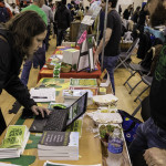 exhibitor talks with attendees about helping farm animals