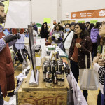 exhibitor talks with attendees about products