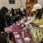 exhibitor talks with attendees about products