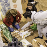 exhibitor shows rolls of patterned wall coverings