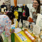 Exhibitor at Boston Veg Food Fest 2024 selling t-shirts and totes