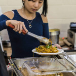 Exhibitor at Boston Veg Food Fest 2024 serves vegan noodles on a plate